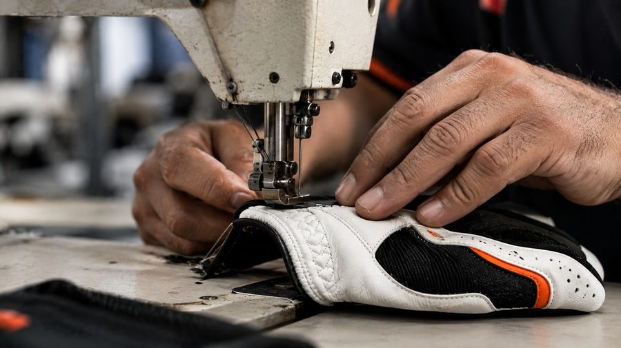 Precision stitching during golf glove production